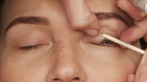 Woman on modern eyelash lamination procedure in a professional beauty salon.